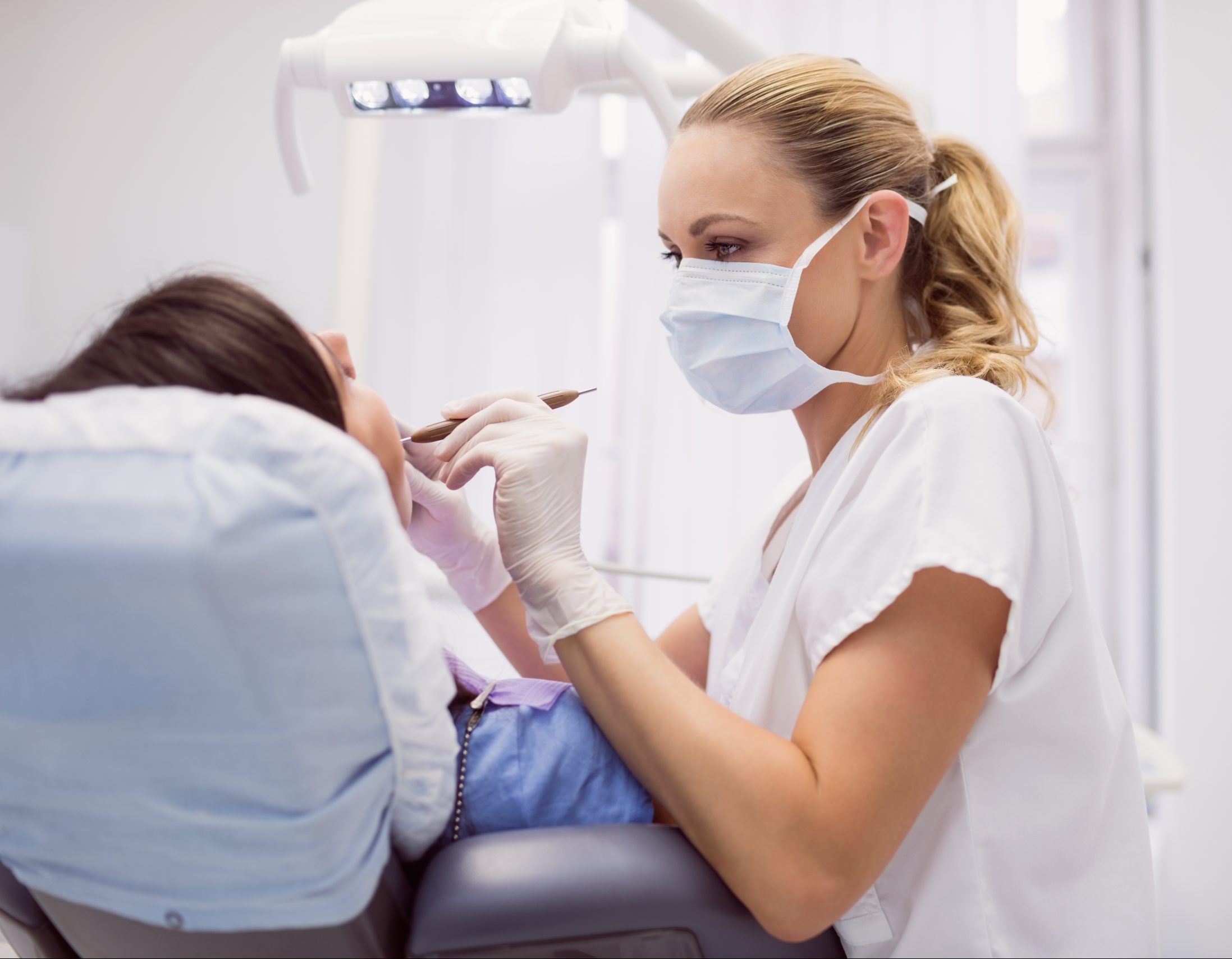 https://www.opti-hc.de/wp-content/uploads/2022/02/dentist-examining-female-patient-scaled-e1645704775321.jpg